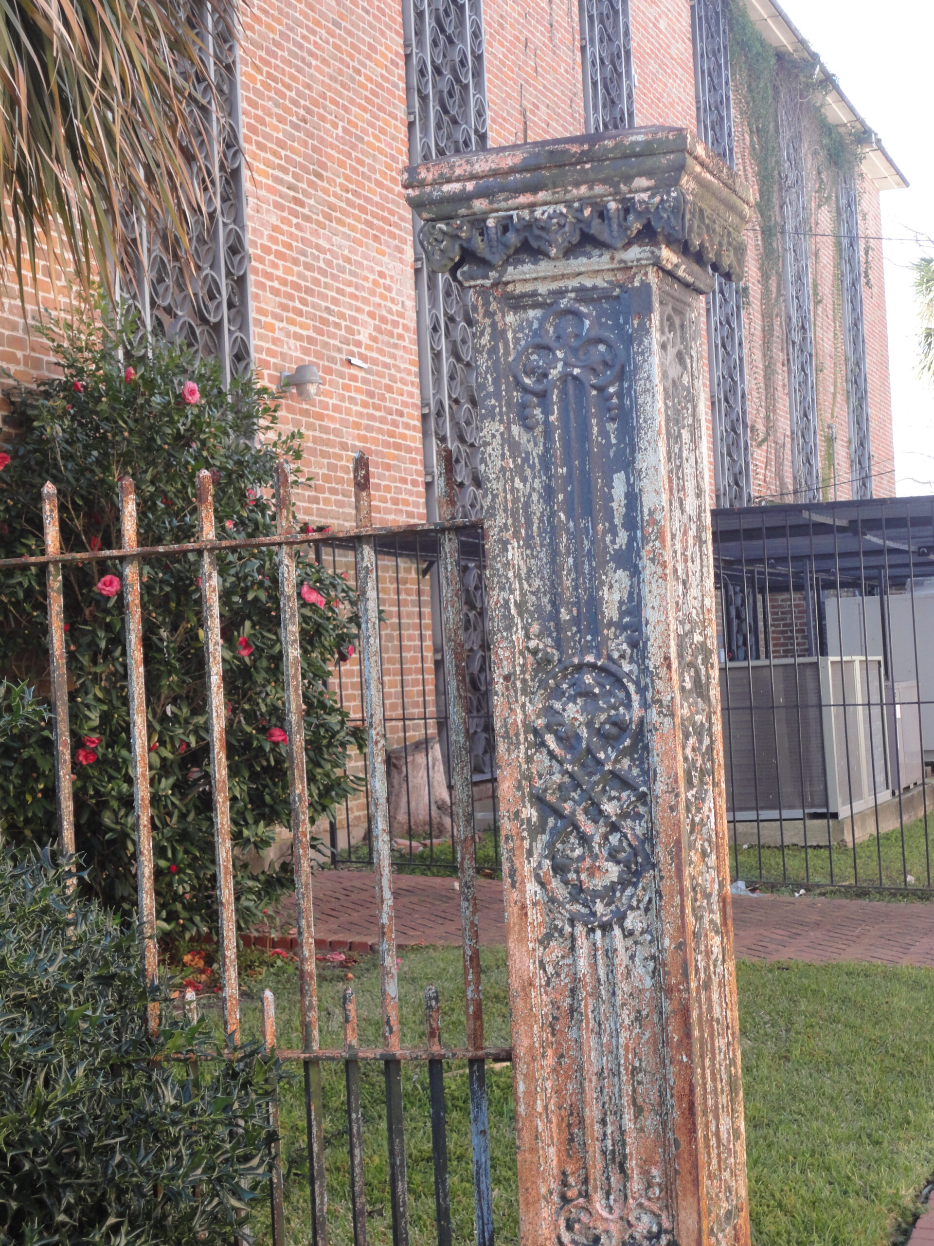 A wrought iron fence in front of a building.