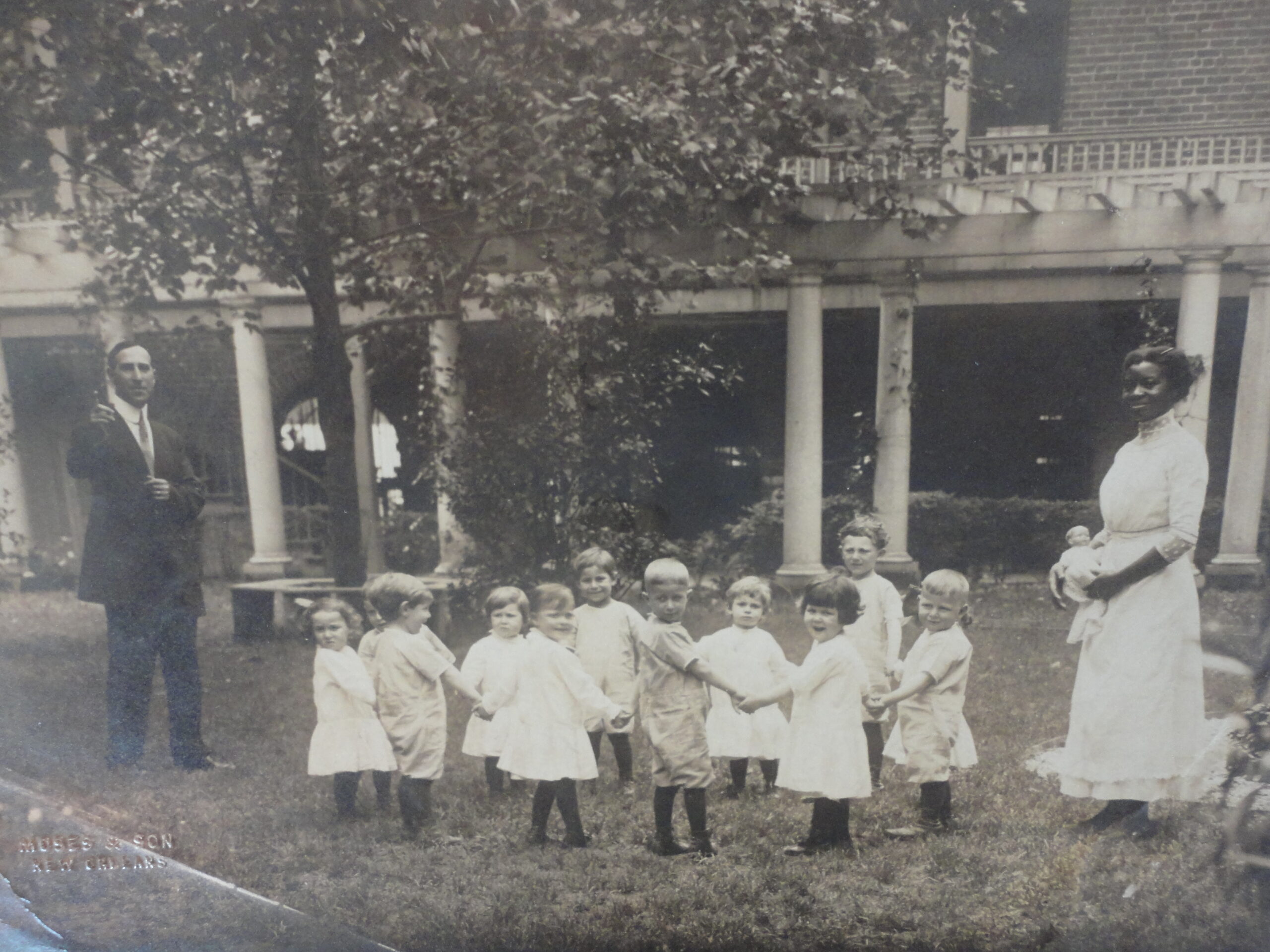 Supt Leon Volmer with unidentified Home children and caregiver, n.d.  