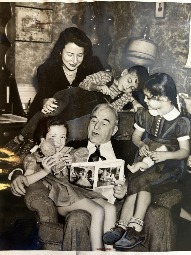 Sylvia Spillman, far right, and Ethel Miron (left) sit on Harry Ginsburg's lap. Jean Avegno at rear and Herbert Freedman on top of chair. 1942.